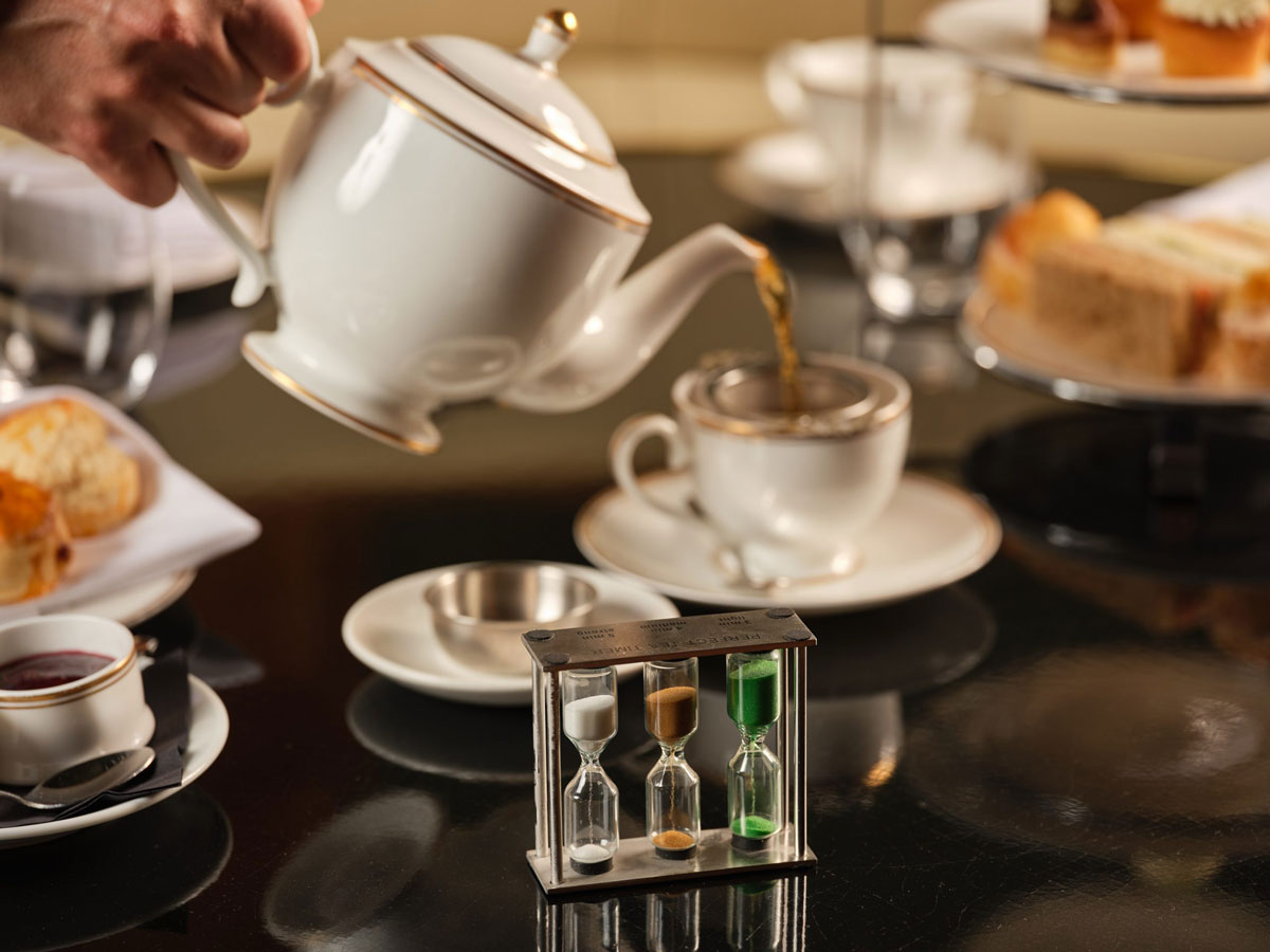 Tea being poured from a tea pot with a sand timer - RAILS Afternoon Tea
